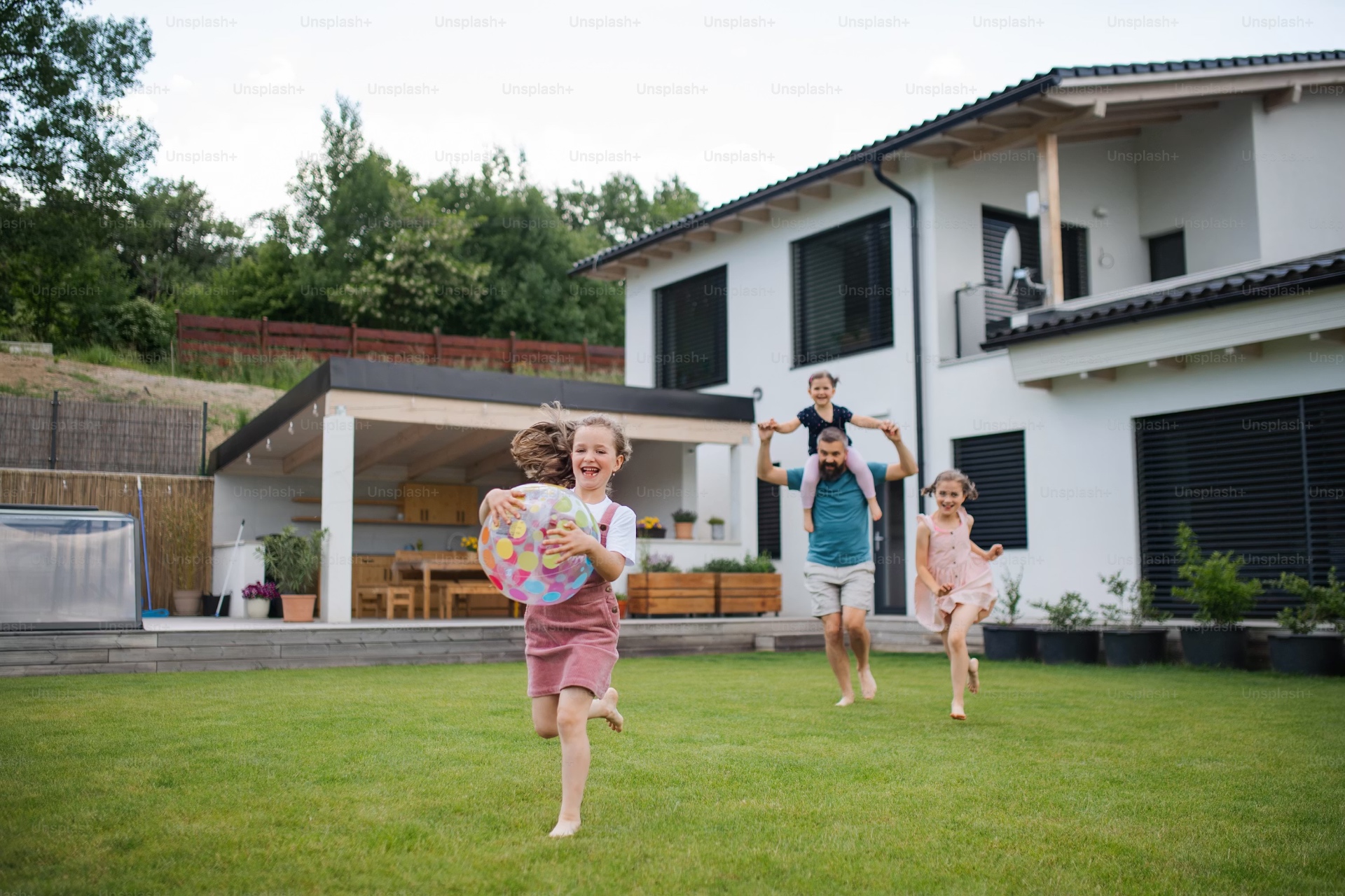 Happy family in front of their home